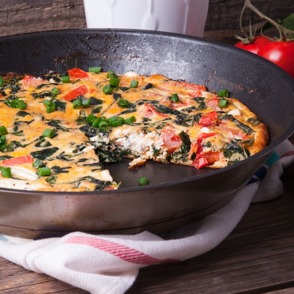 Spinach and Sun Dried Tomato Frittata in a cast iron skillet