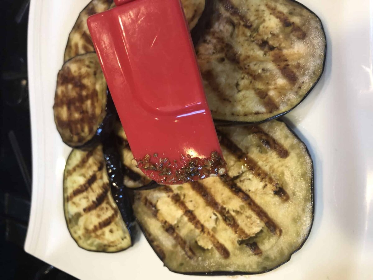 Brushing the Eggplant with Seasoning on a white plate