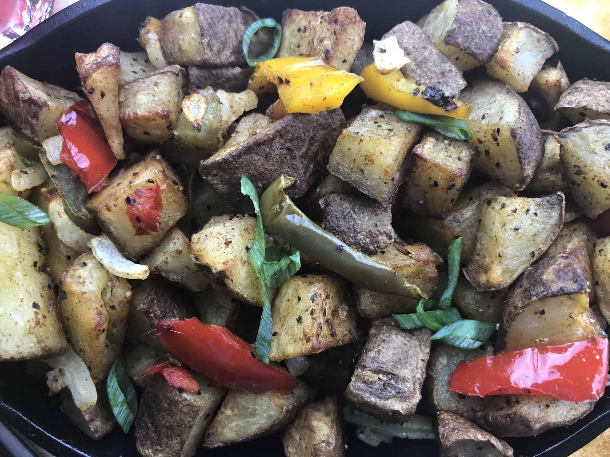 Air Fryer Home Fries with diced peppers in a black dish