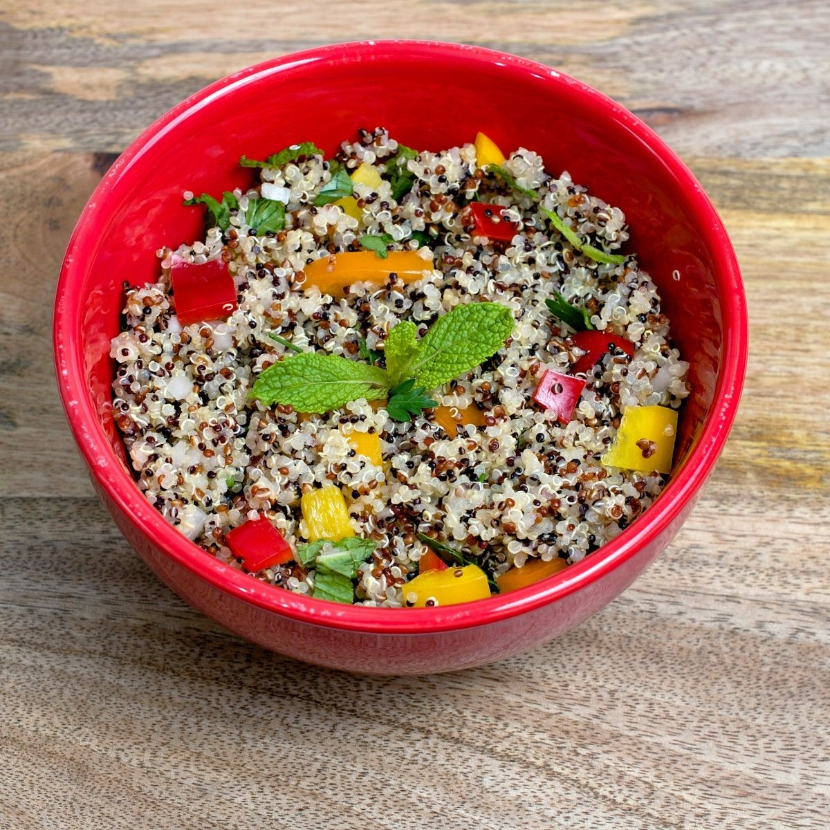 Keto quinoa salad in a red bowl