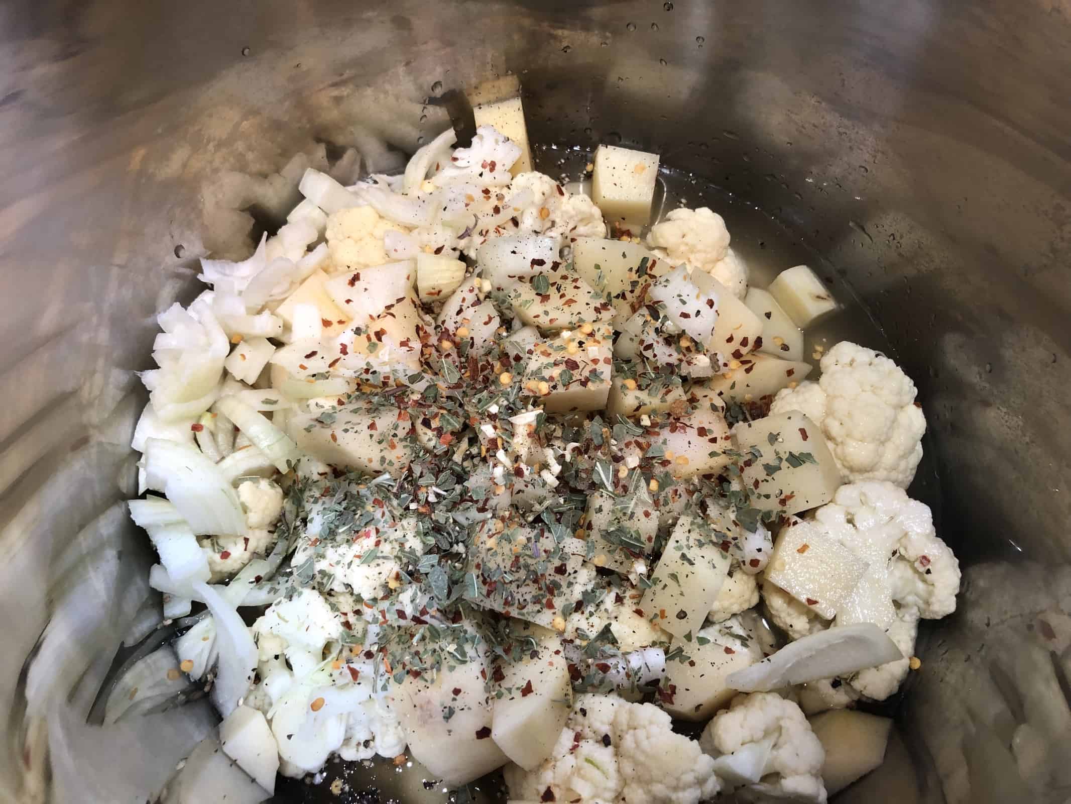 Cauliflower and potatoes and onions and spices in an instant pot