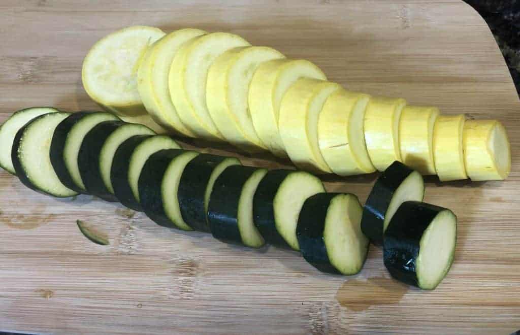 Sliced Zucchini and Squash on a wooden cutting board