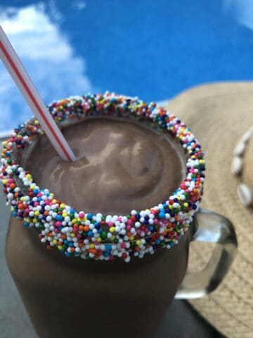 Candy coated rim of a chocolate avocado milkshake
