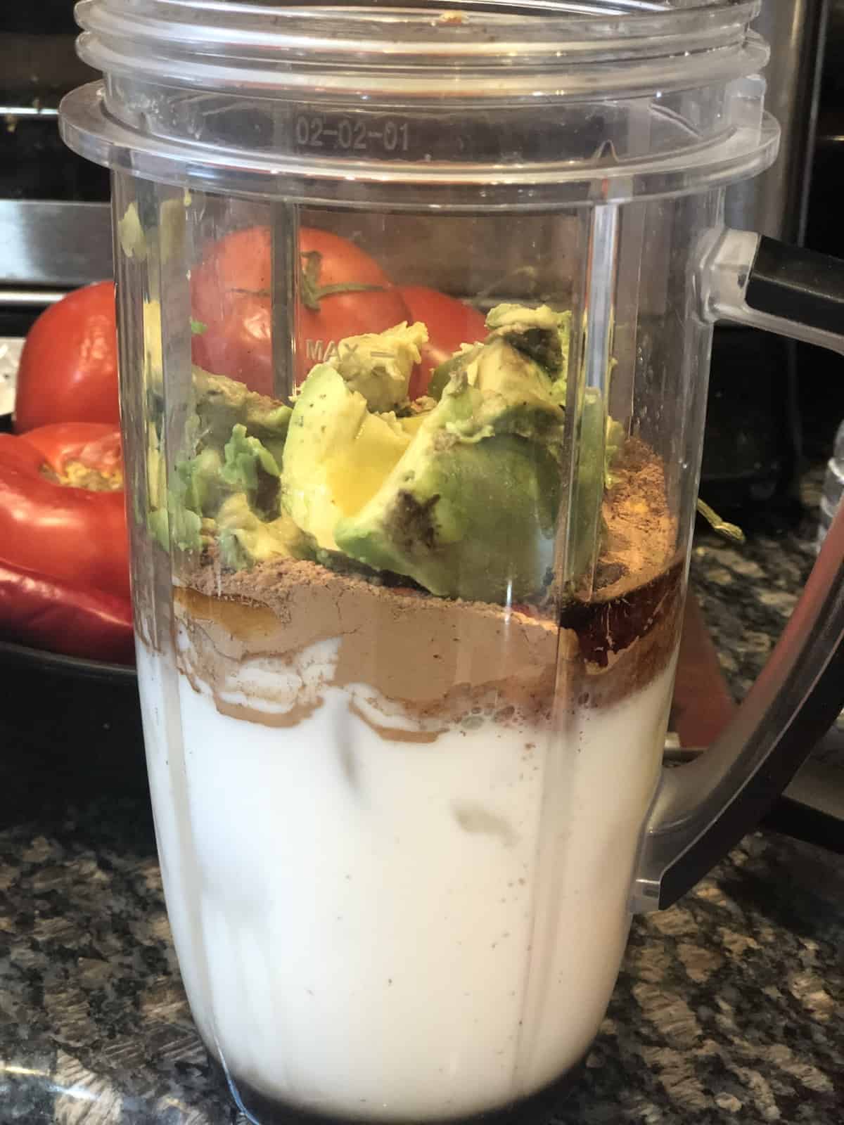 almond milk avocado and cocoa powder in the Nutribullet cup