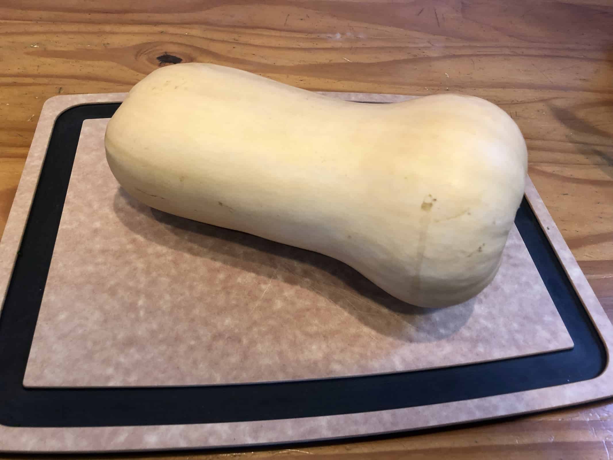 Butternut Squash on a cutting board on a wooden table