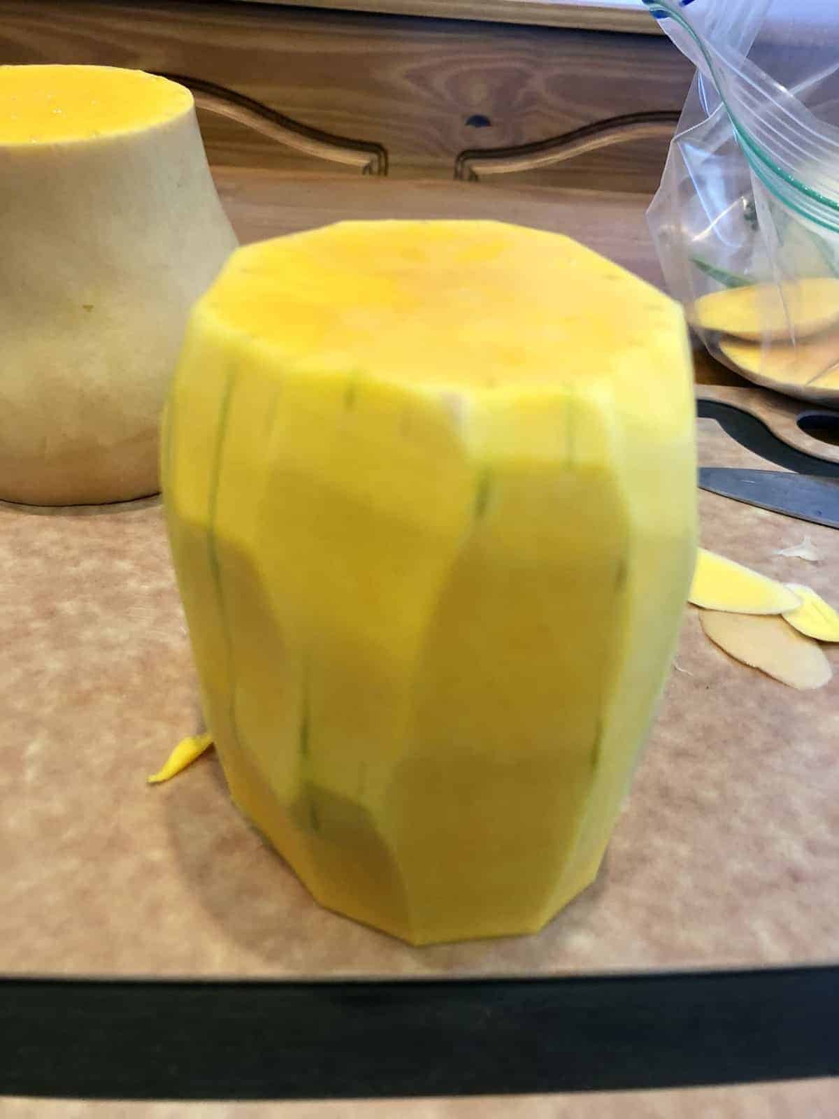 the peeled butternut squash on a cutting board