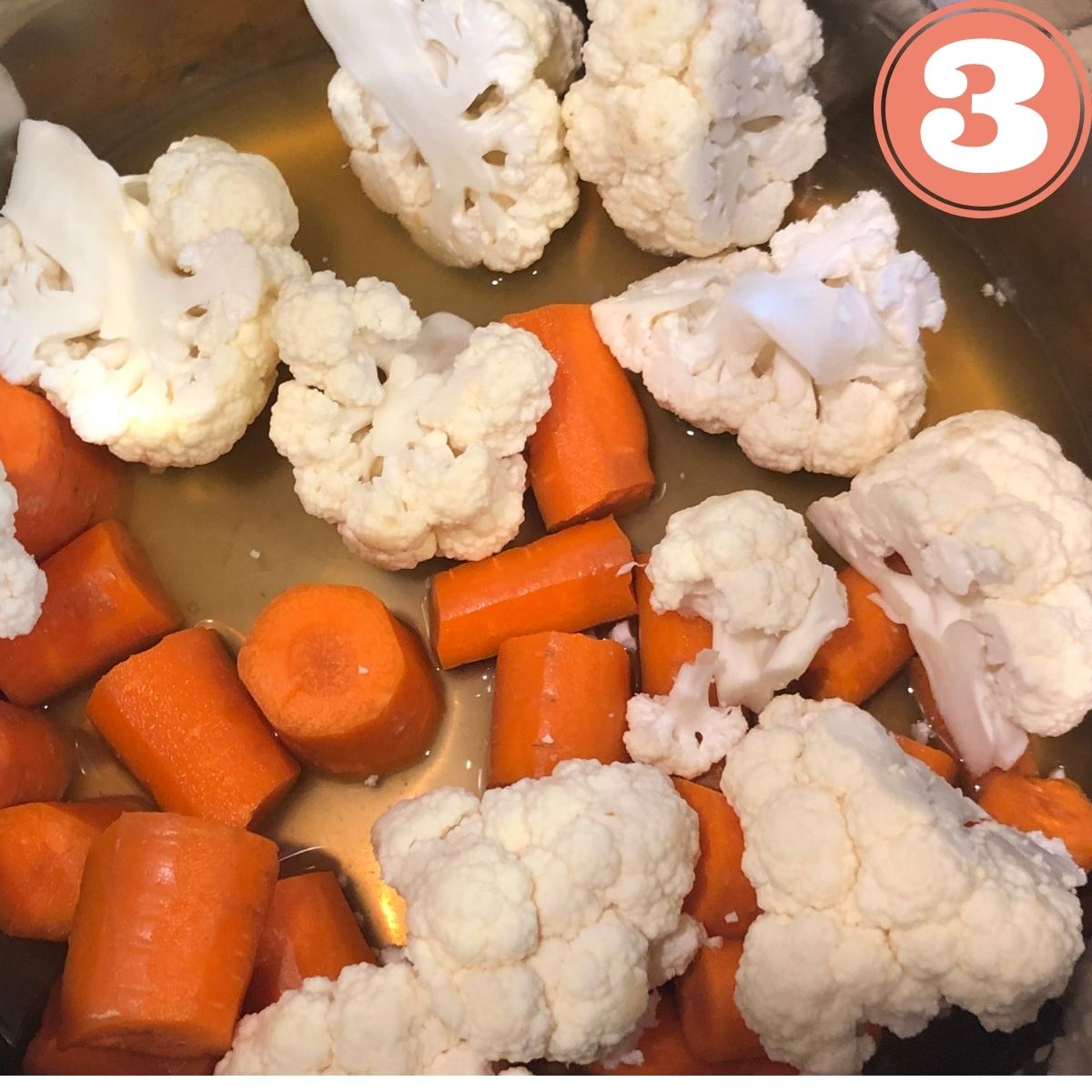 chopped cauliflower florets and diced carrots in vegetable broth in an instant pot