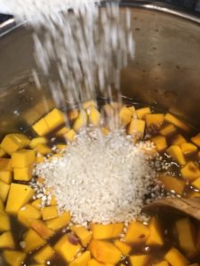 filling the instant pot with rice and squash