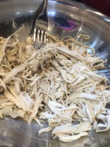 Shredding the chicken for the  homemade chicken noodle soup