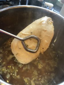 Removing the chicken breast from the instant pot