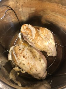 Browned chicken breasts on trivet