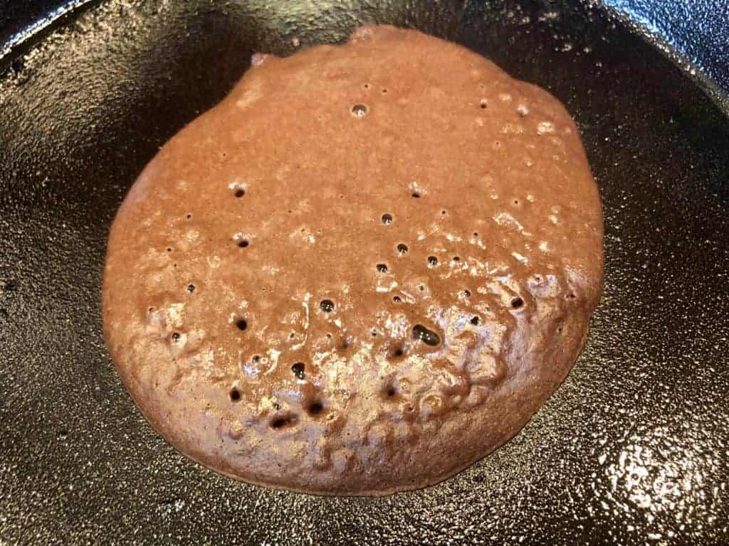 cooking pancakes in a cast iron skillet