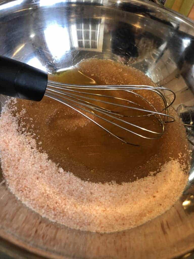 Pink Sea Salt and Oils for natural scrub in a mixing bowl