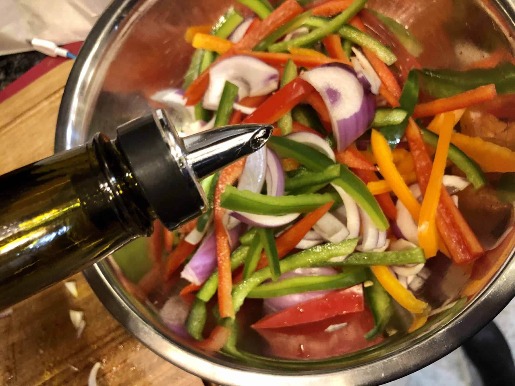 Adding Olive Oil to Peppers and Onions