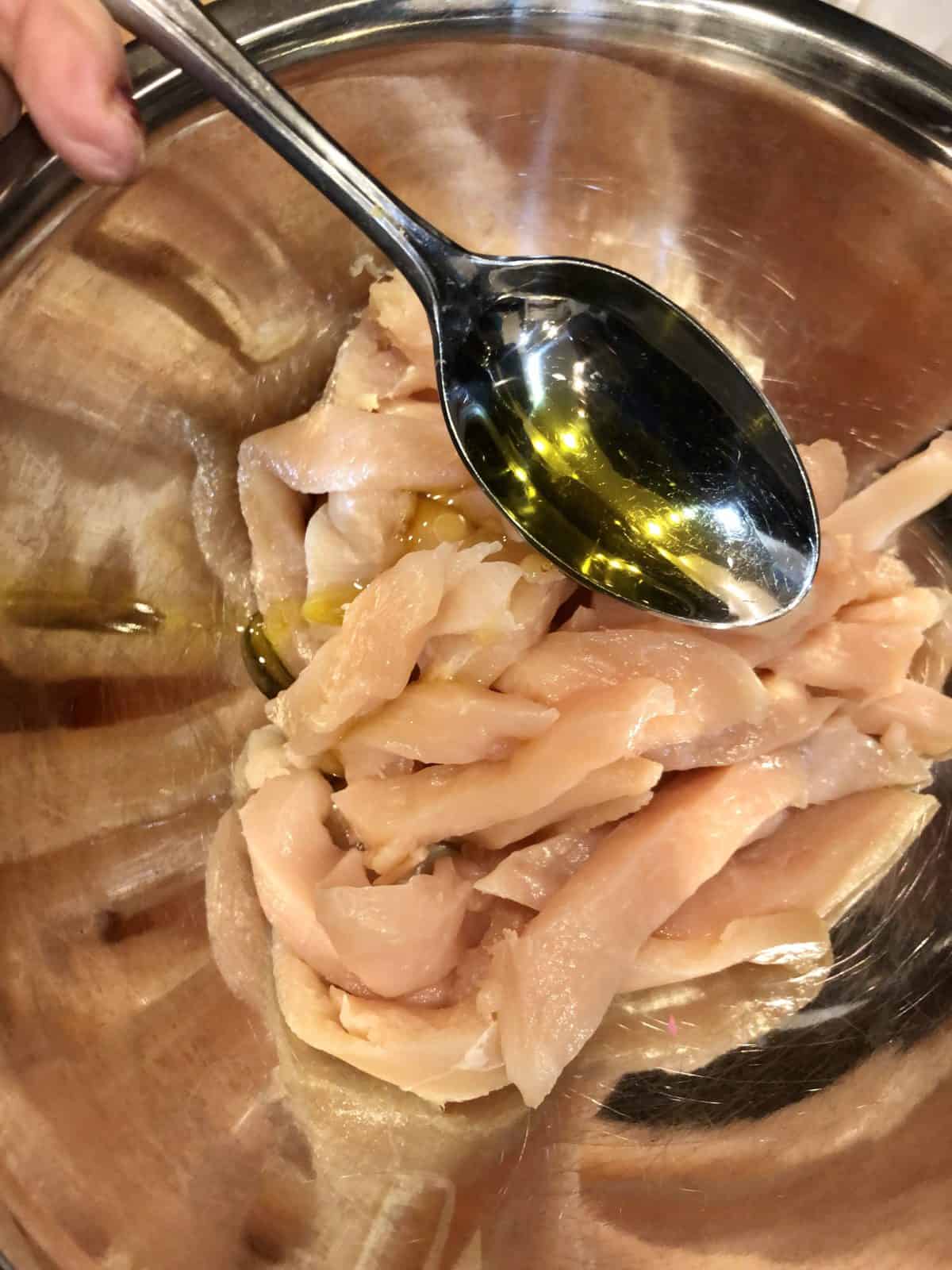Coating chicken strips with Olive Oil