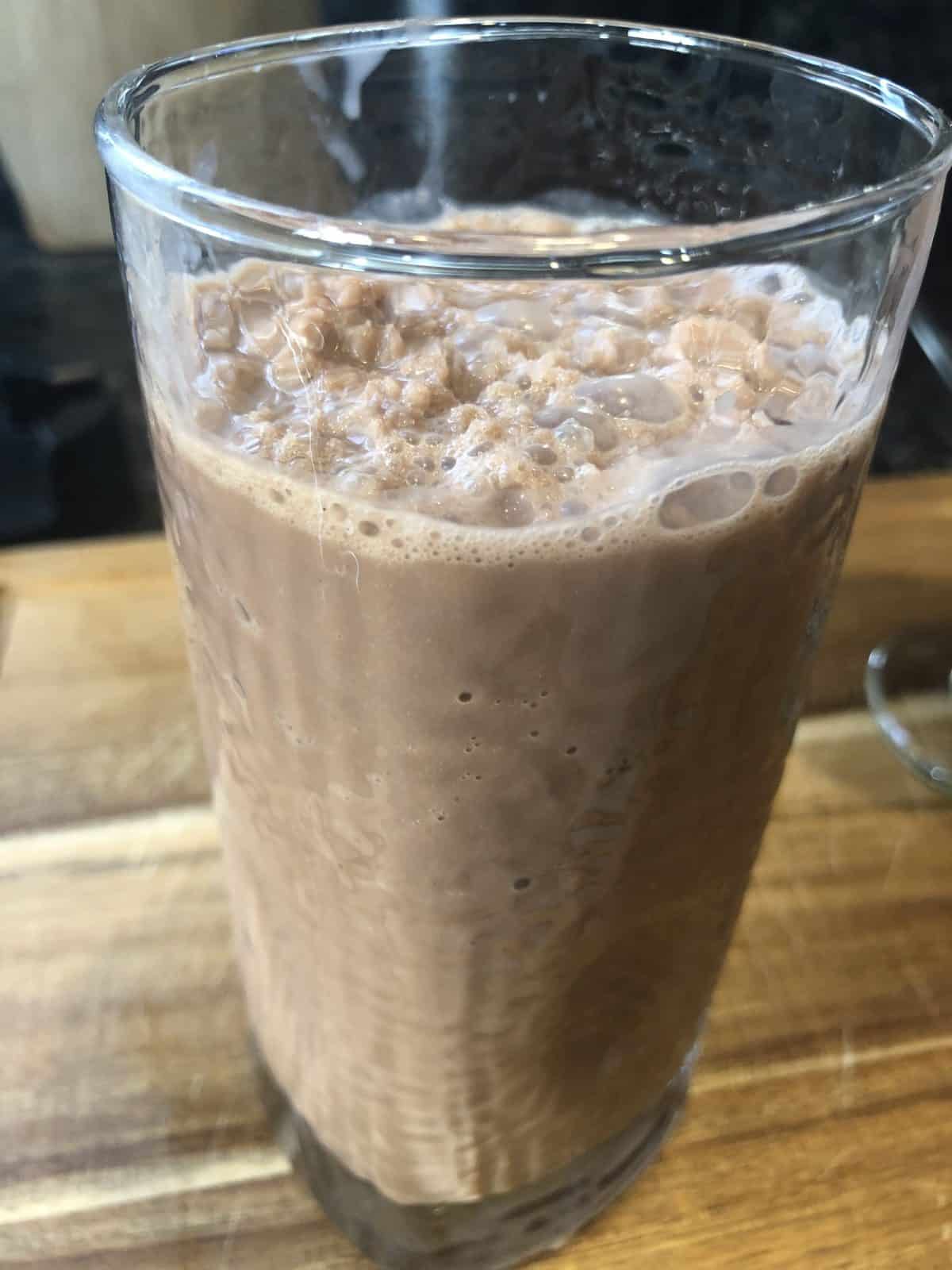 Wendy's Copycat Low Carb-Low Calorie Chocolate Frosty in a clear glass on a wooden table