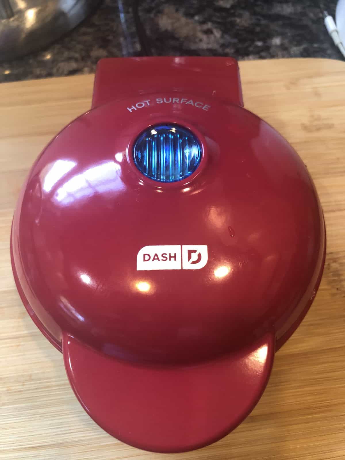 A red DASH Mini Waffle Maker