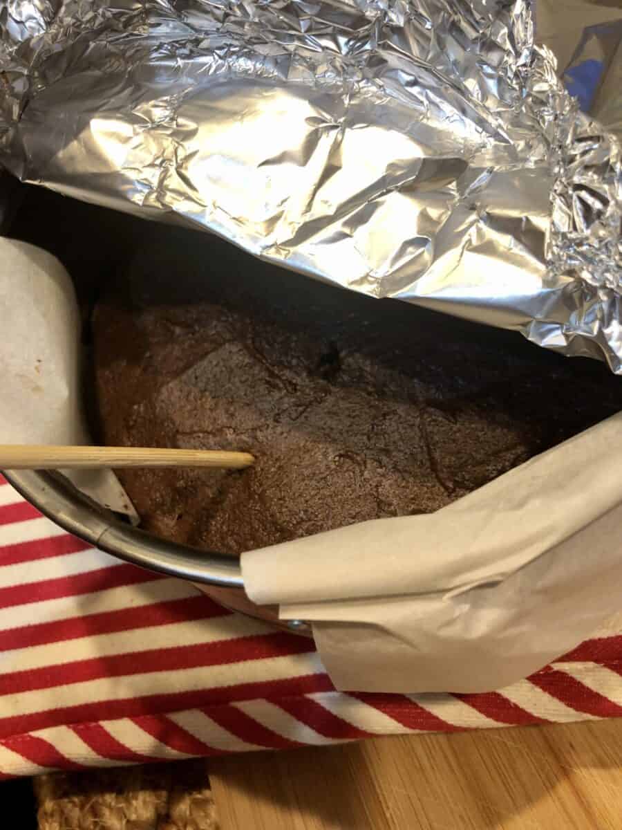 Toothpick in Air Fryer Chocolate Cake in a springform pan with aluminum foil folded back