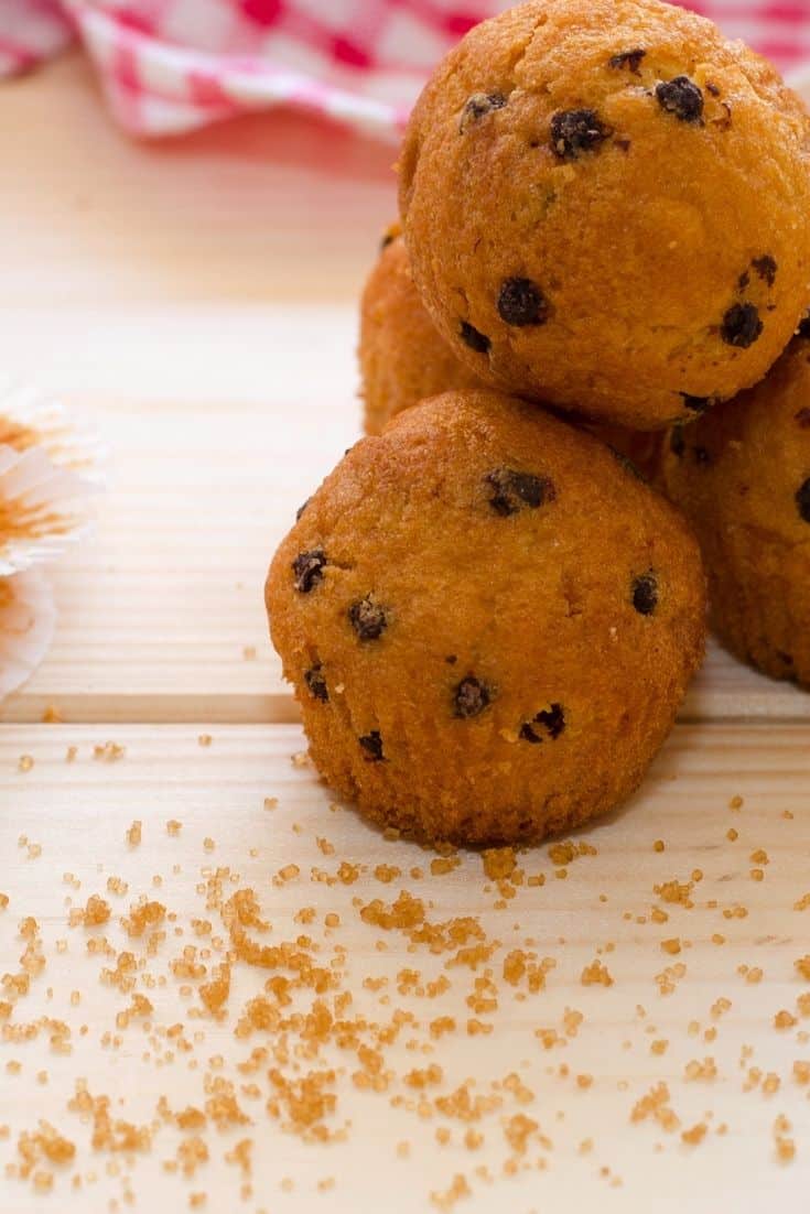 Mini Chocolate Chip Muffins stacked on a wooden cutting board