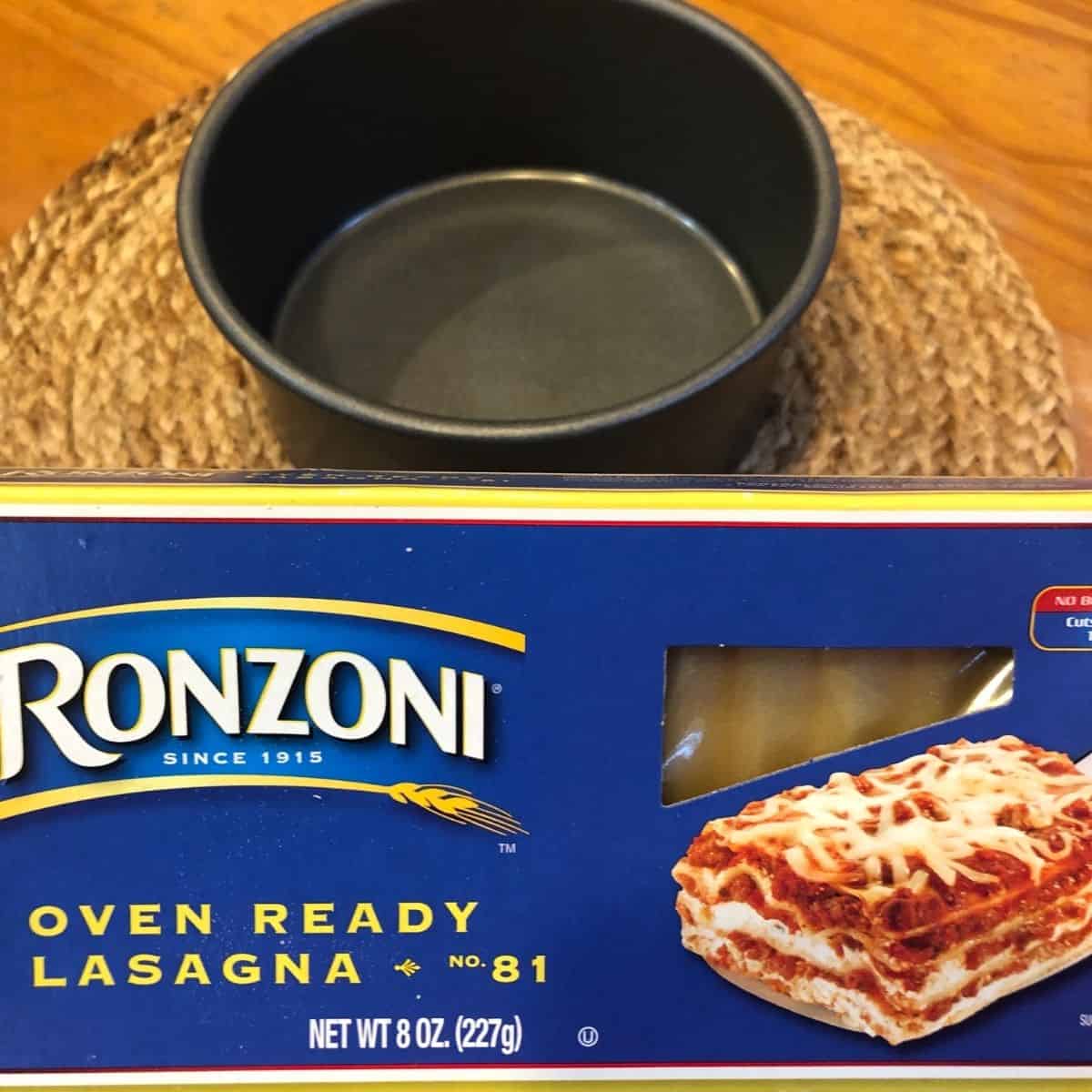round lasagna pan and no bake lasagna noodles on a wooden table