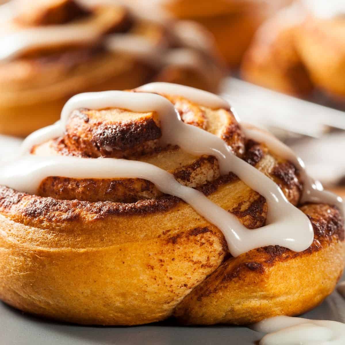 Homemade cinnamon bums with icing drizzled on top