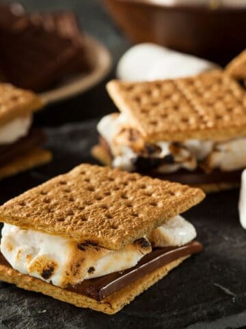 Graham cracker s'mores on a table with marshmallows