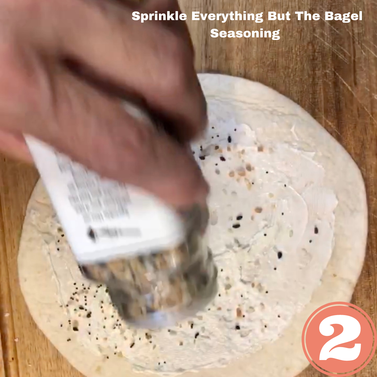 Sprinkling Everything But The Bagel Seasoning on a tortilla