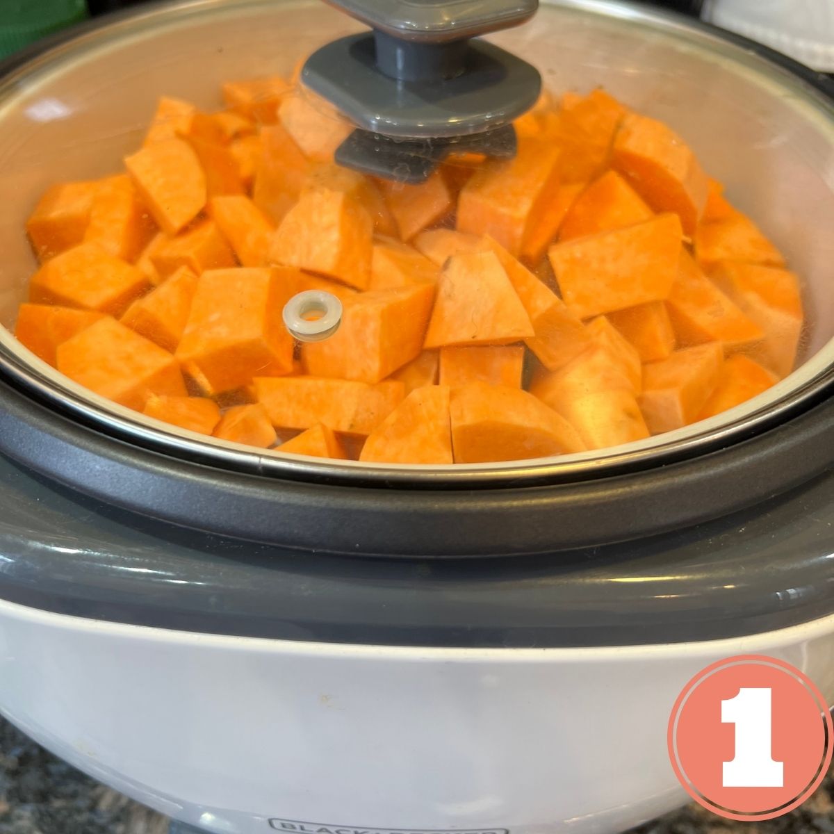 Cubed sweet potatoes in a Black & Decker steamer pot