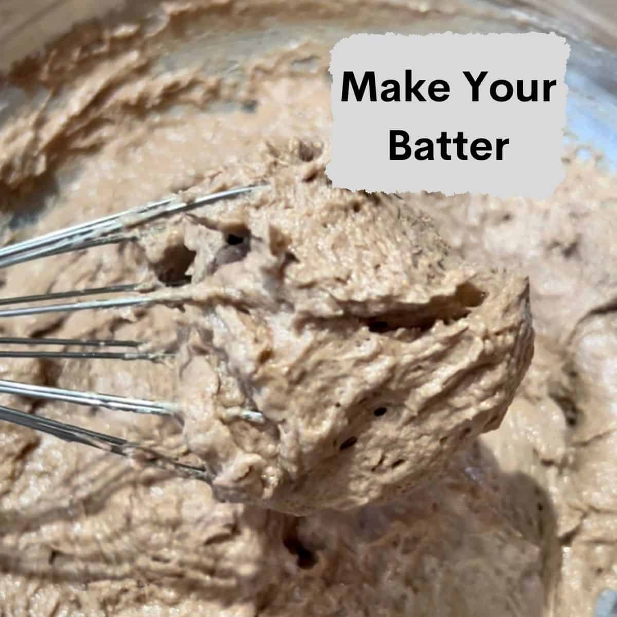 Chocolate eggless cookie batter on a whisk