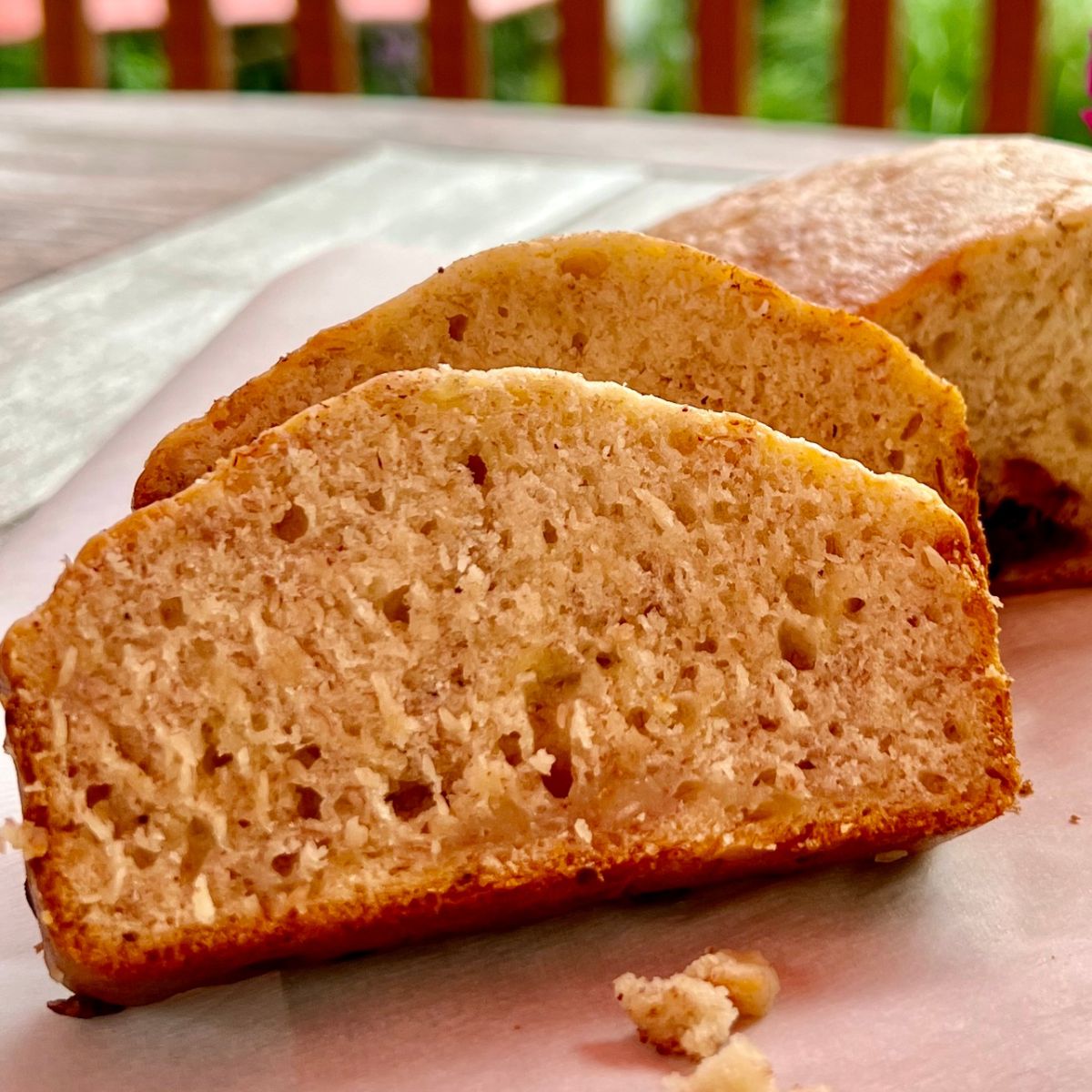 Slices of Banana Eggless Bread on a wooden picnic table