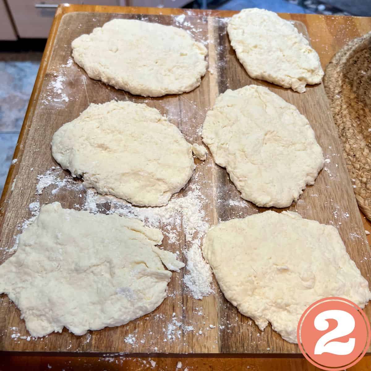 Naan bread dough on a wooden table