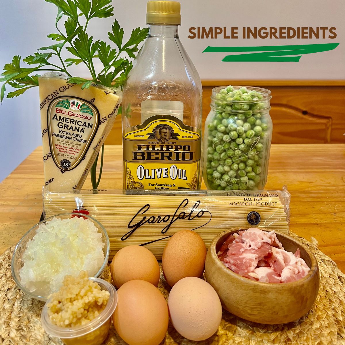 pasta carbonara ingredients on a wooden table parmesan cheese, olive oil, peas,onion,eggs and bacon