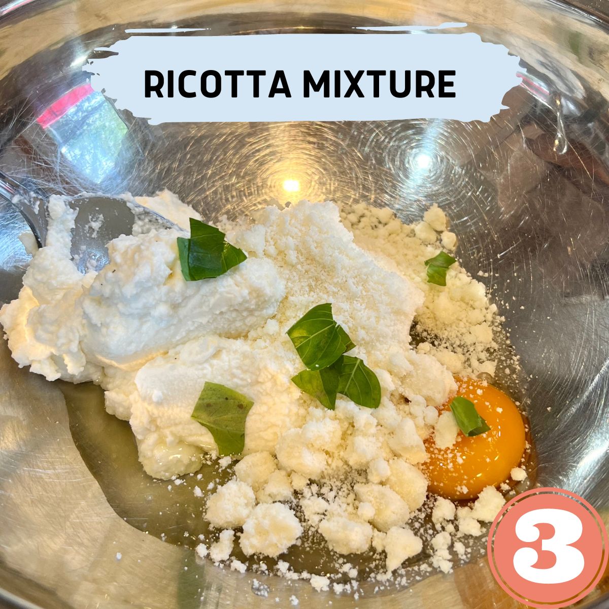 Ricotta cheese, egg,parmesan cheese and basil in a stainless steel bowl