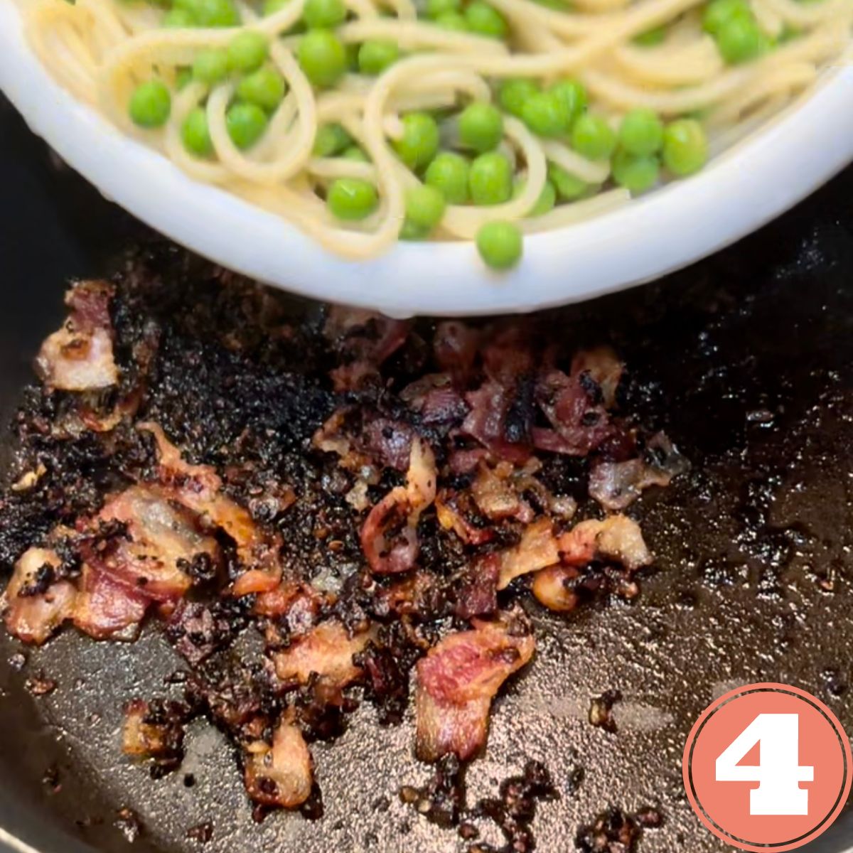 Pasta and peas being poured into a skillet with crispy bacon