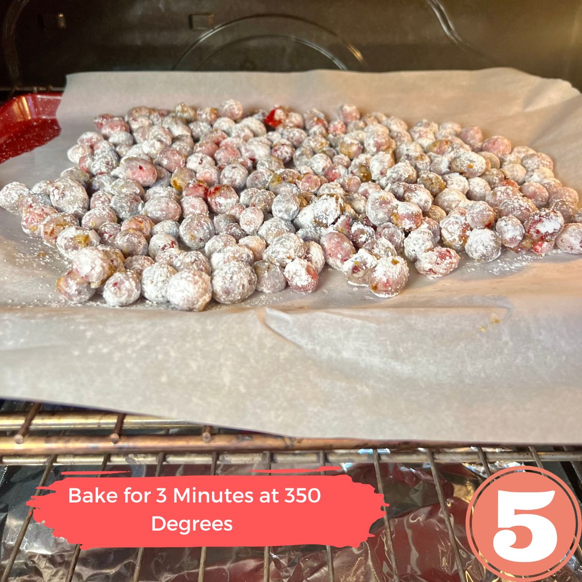 Candied cranberries on a parchment lined baling sheet in the oven