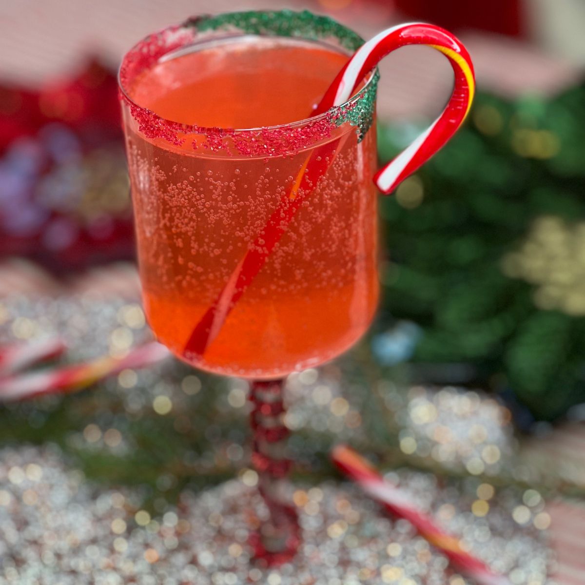 Zero calorie mocktail in a clear glass with a candy cane stir