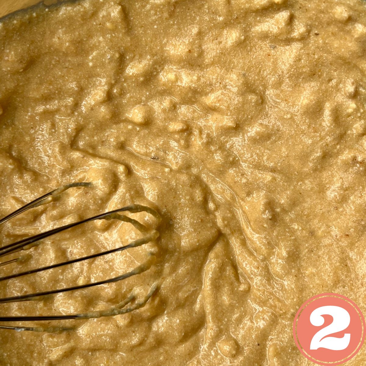Pumpkin apple ricotta muffin batter with a whisk