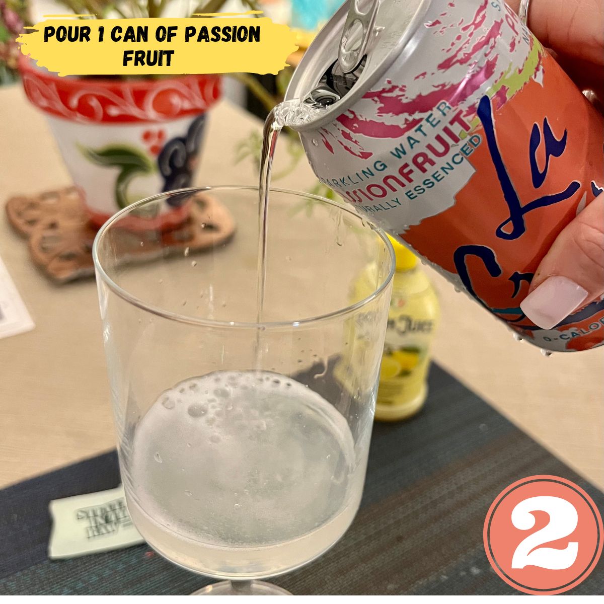 pouring a can of La Croix Passion Fruit Sparkling water into a glass