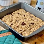 Baked oatmeal in a baking pan on a wooden table