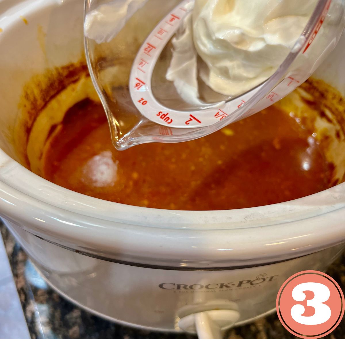 Greek yogurt in a measuring cup being added to a crockpot filled with salsa
