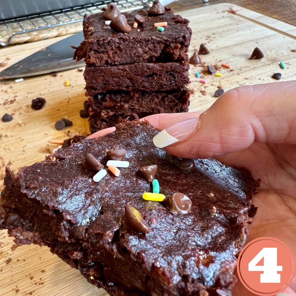 A hand holding a three ingredient chocolate brownie