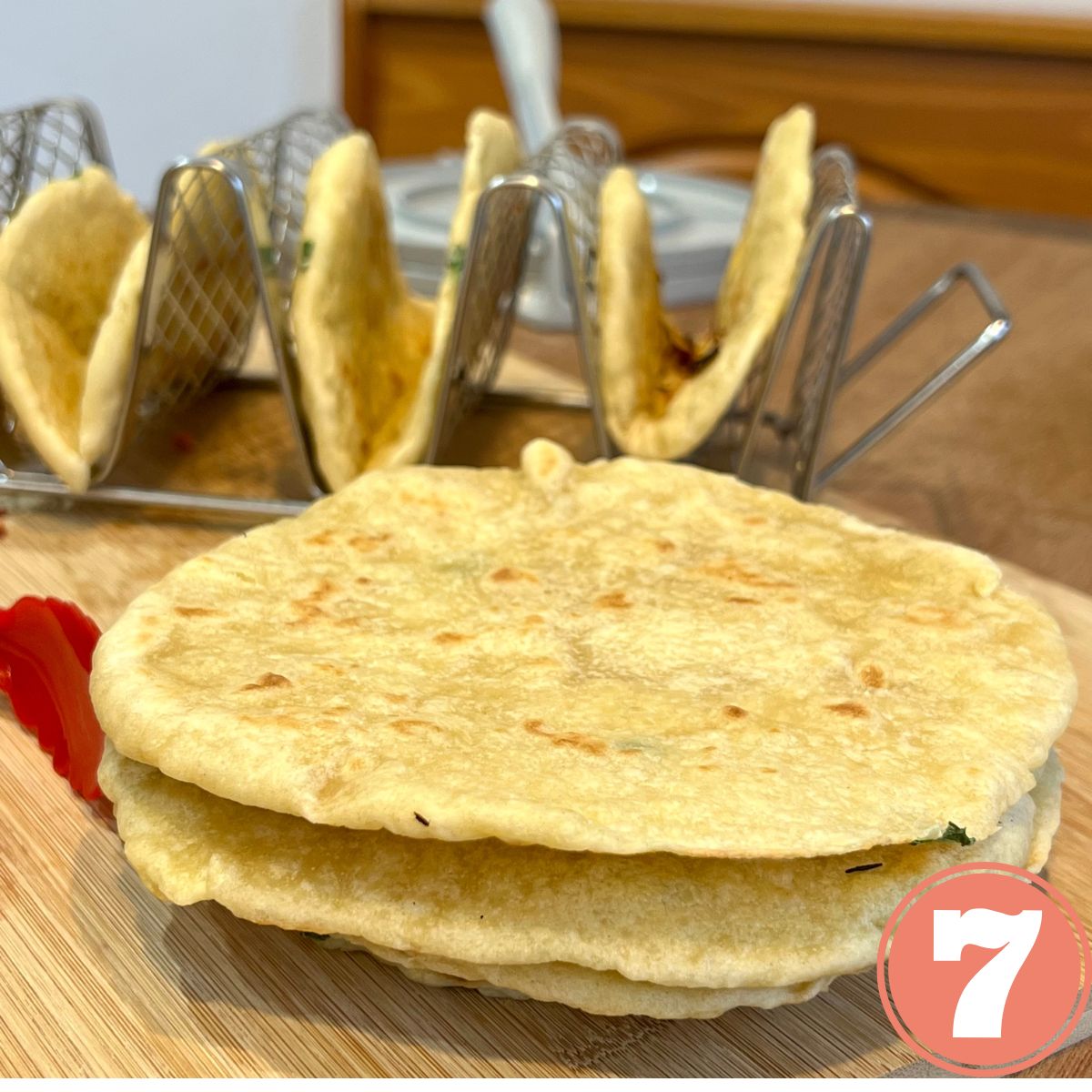 A stack of homemade flour tortillas and homemade taco shells