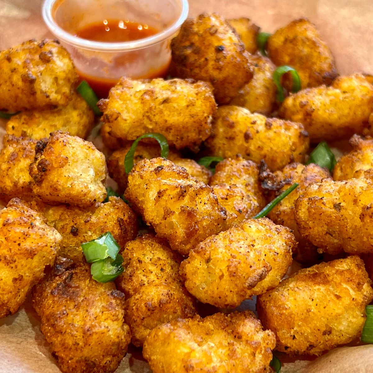 Air Fryer Tater Tots with a side of hot sauce