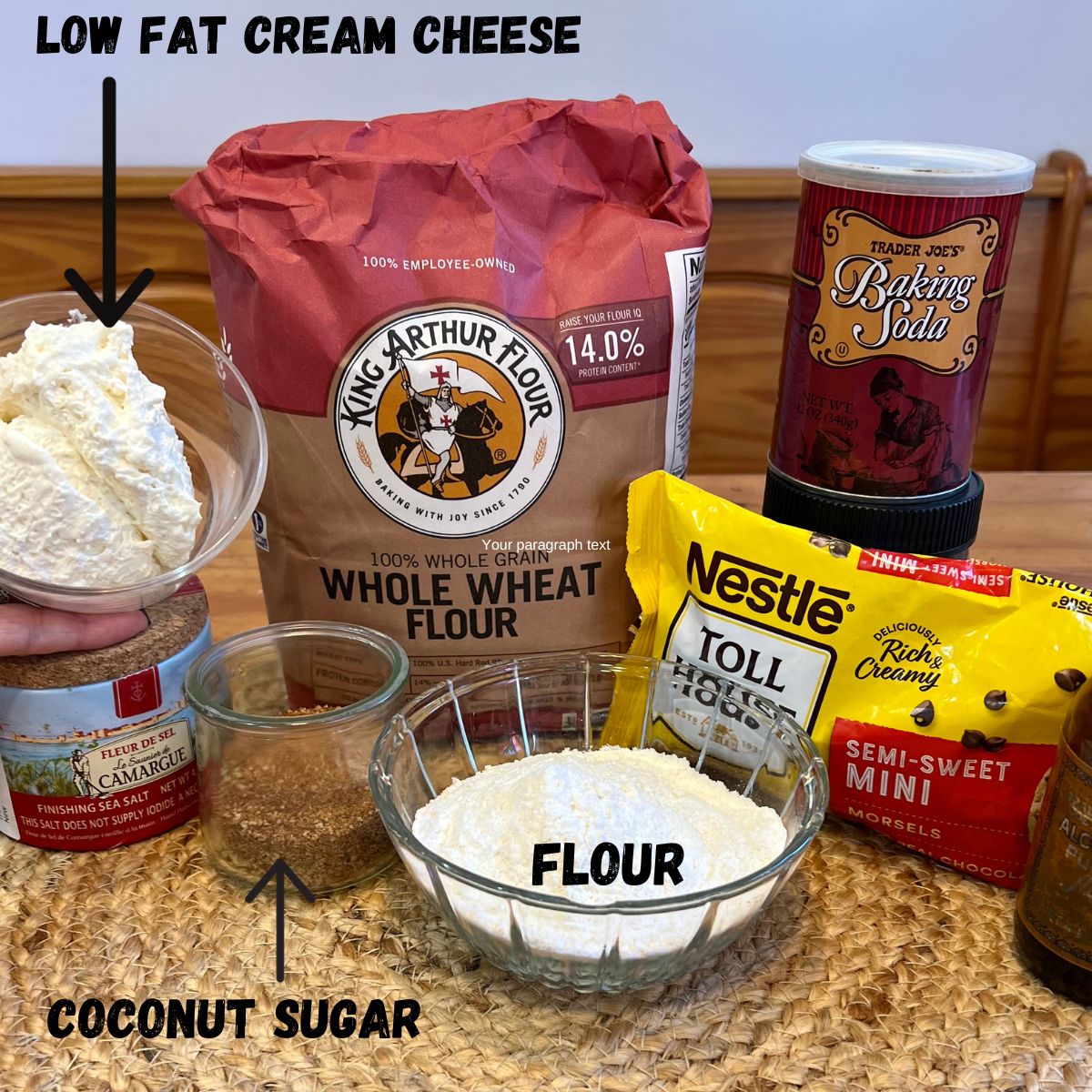 Cream cheese cookie ingredients - a bowl of low fat cream cheese, whole wheat flour in a bag, baking soda, sea salt, coconut sugar, flour and a bag of nestle's chocolate chips