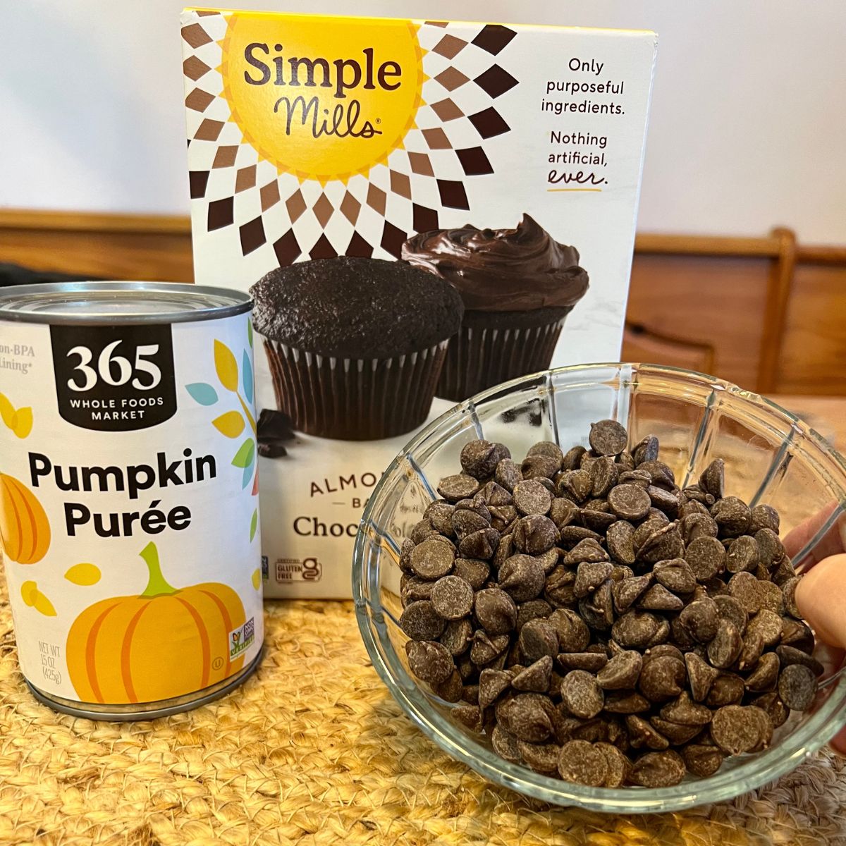 Chocolate pumpkin muffin ingredients a can of pumpkin puree a box of  Simple Mills Chocolate cake mix and a bowl of chocolate chips