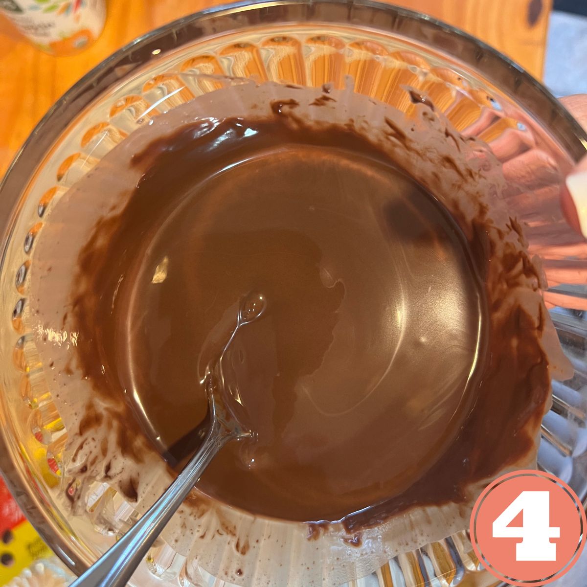 a bowl of melted chocolate with a spoon in it