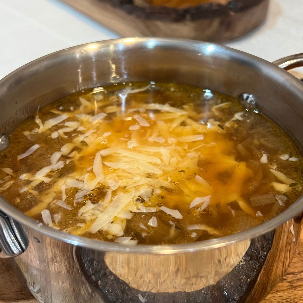 Healthy crockpot French onion soup in a stainless steel bowl