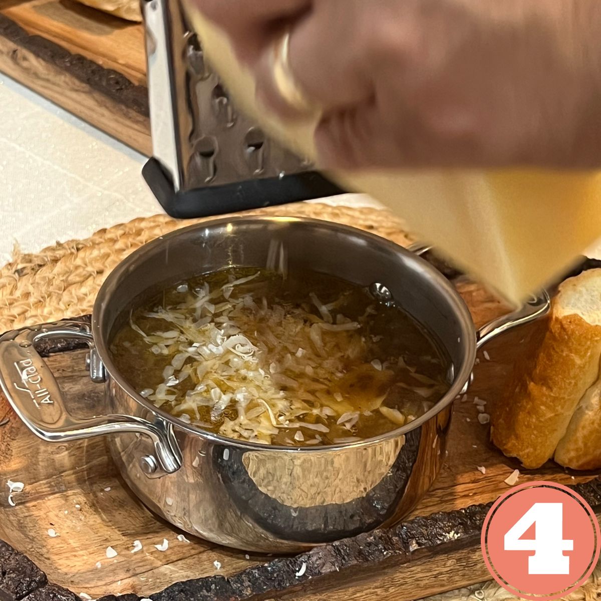 Parmesan cheese being grated into French onion soup