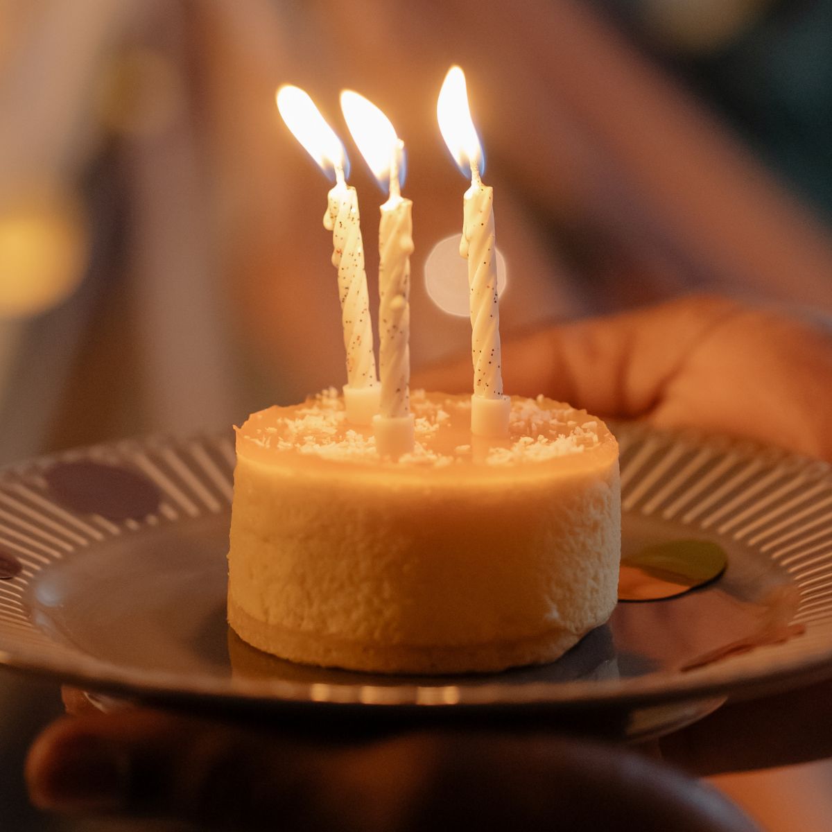Mini dessert cake with candles on a plate