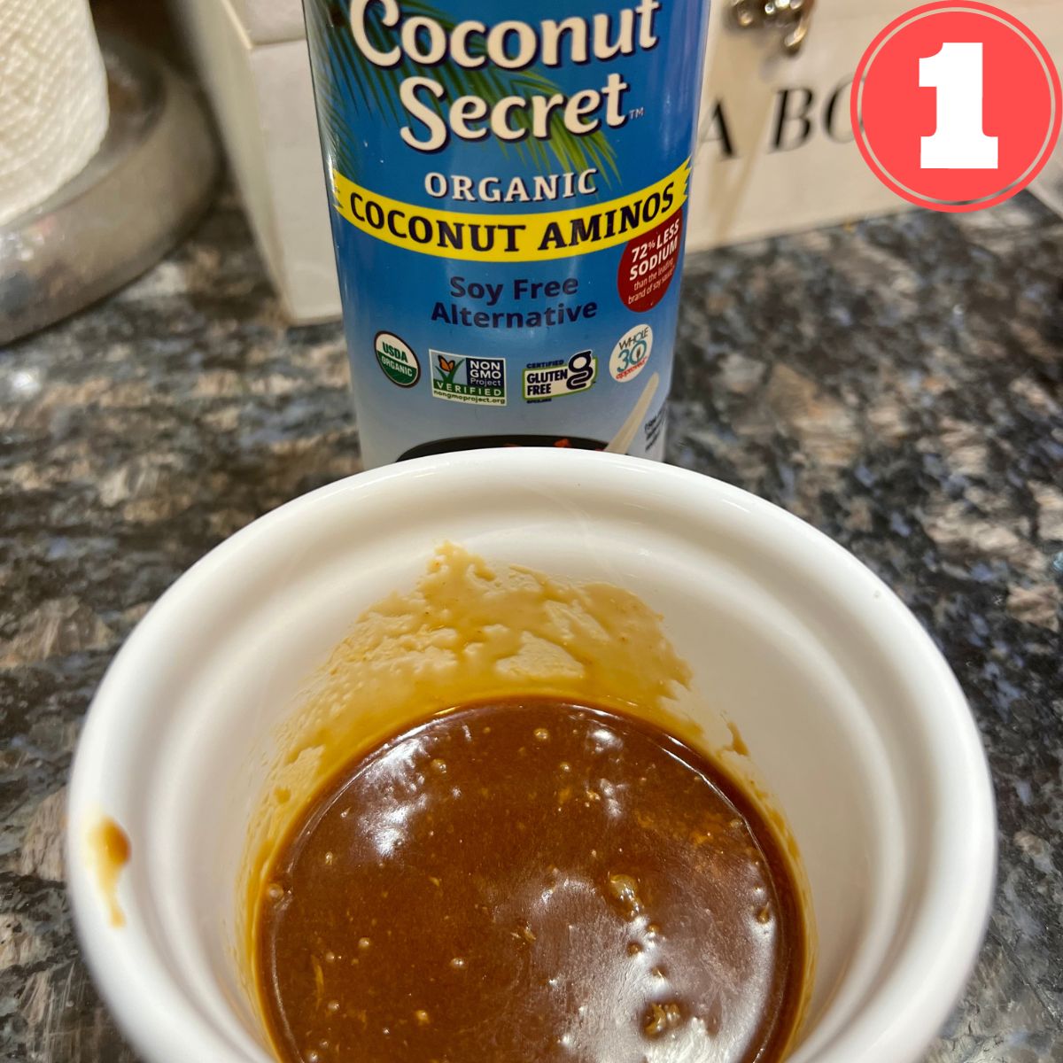 Coconut amino hot sauce in a small white bowl